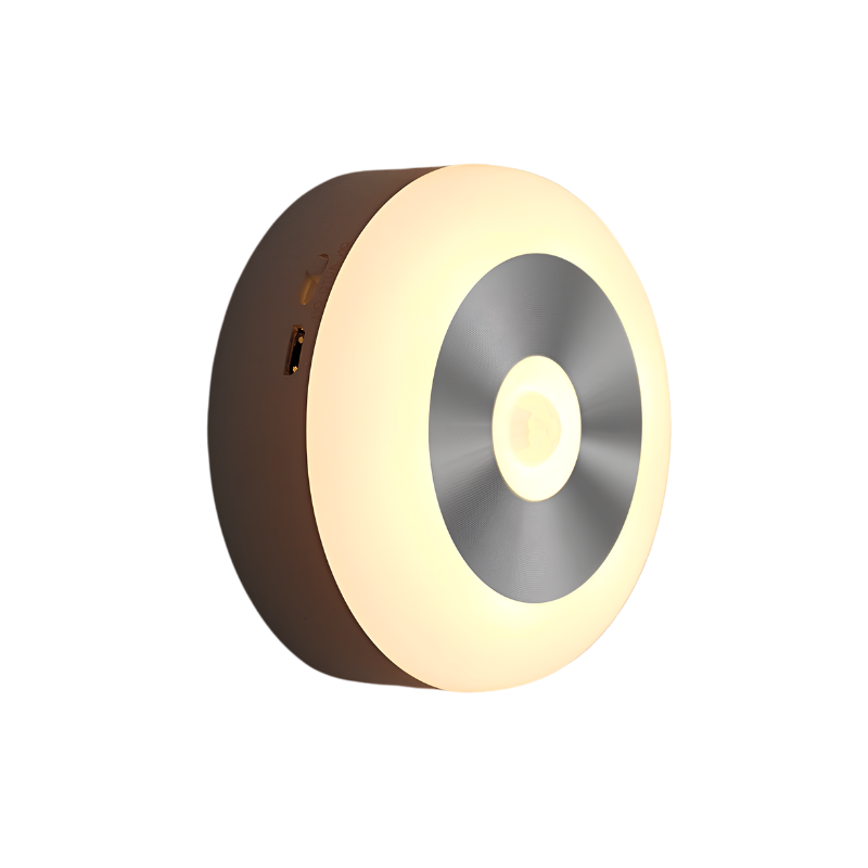 Luce notturna LED circolare con sensore di luce e touch, accende automaticamente al buio, alimentata a batteria.