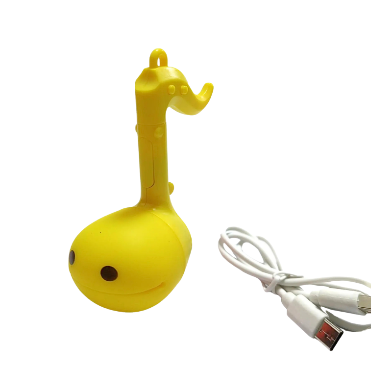 Ottamaton Mini yellow electronic instrument shaped like a music note with USB charging cable. Cute plastic toy.