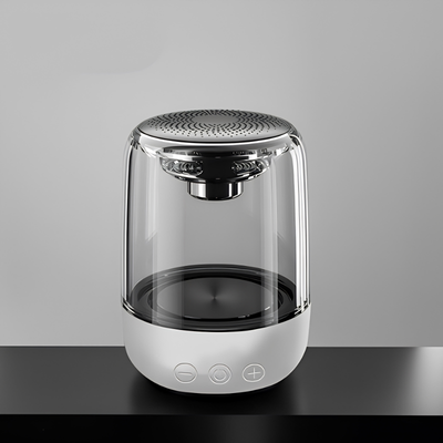 Altoparlante Bluetooth portatile a colonna, corpo trasparente e base bianca, luci LED colorate variabili.