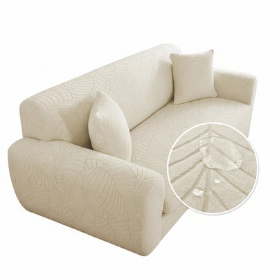 Copertura elastica beige per divano a due posti, motivo foglie, trama tessuto mostrata in ingrandimento.